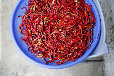 High angle view of red chili peppers in bowl on table