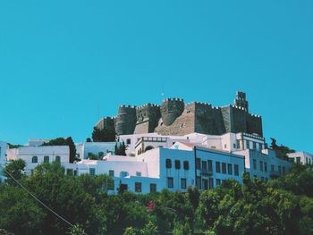 Buildings against clear blue sky