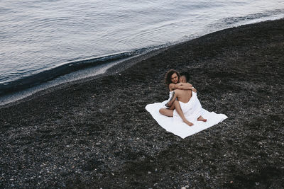 High angle view of woman relaxing on beach