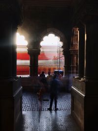 People walking in historic building