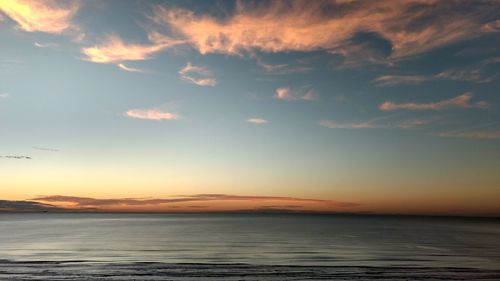 Scenic view of sea against sky at sunset