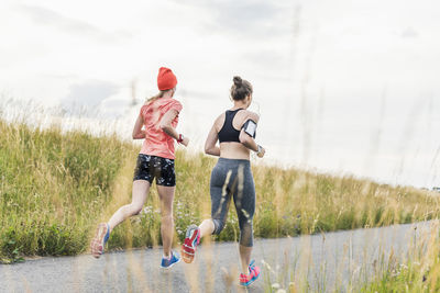 Two women running in the countryside