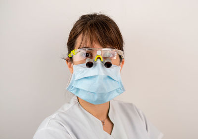 Portrait of man wearing mask against white background