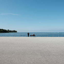 People on beach against sky