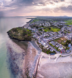 High angle view of city by sea against sky