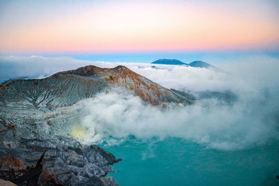 Panoramic view of volcanic mountain against sky during sunset