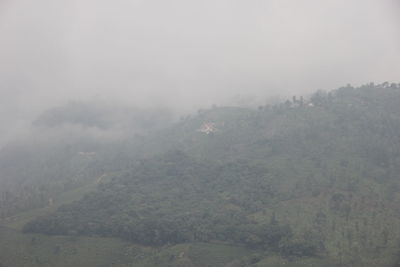 Scenic view of landscape against sky during foggy weather