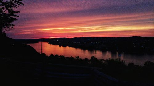 Scenic view of lake against romantic sky at sunset