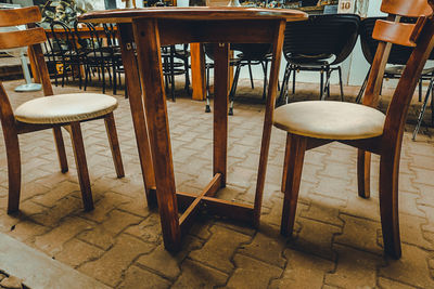 High angle view of empty chairs and table in restaurant