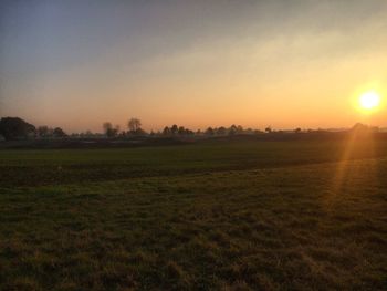 Scenic view of field against sky during sunset