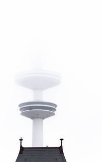 Low angle view of communications tower against clear sky