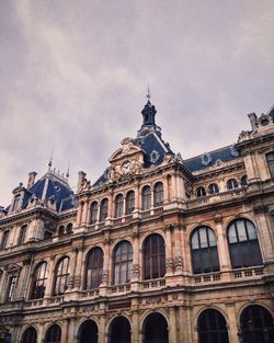 Low angle view of historic building against cloudy sky