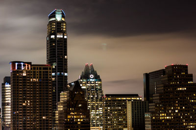 Low angle view of illuminated cityscape against sky