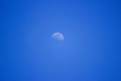 Close-up of moon against blue sky