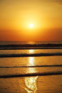 Scenic view of sea against orange sky