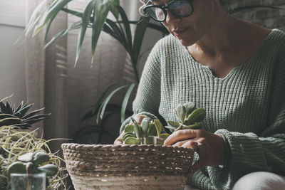 Close-up of man with potted plant at home