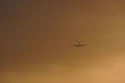 Silhouette of commercial airplane in evening sky