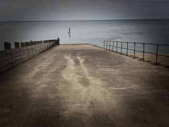 Pier over sea against sky
