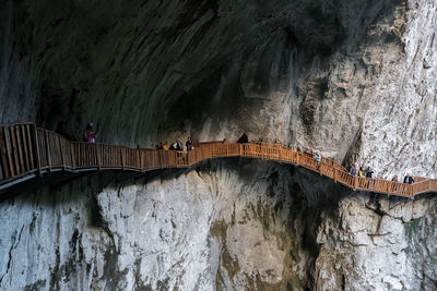 Panoramic view of cave and wooden bridge