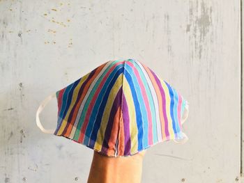 Close-up of hand holding multi colored wall