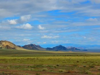 Scenic view of mountains against cloudy sky