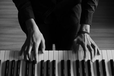 Midsection of woman playing piano