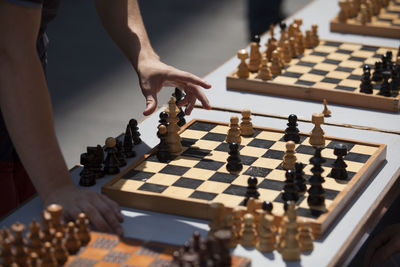 Midsection of man playing chess on table