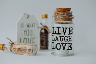 Close-up of glass jar on table against white background