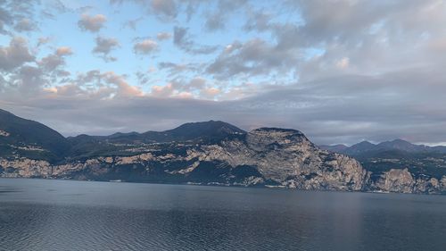 Scenic view of sea and mountains against sky