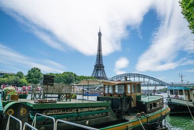 View of ship in city against cloudy sky