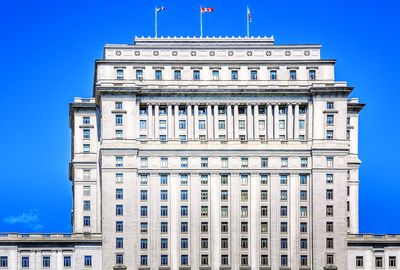 Low angle view of buildings against blue sky