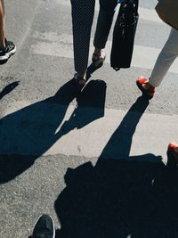 Low section of people walking on road