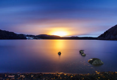 Scenic view of lake against sky during sunset