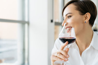 Young woman holding wineglass