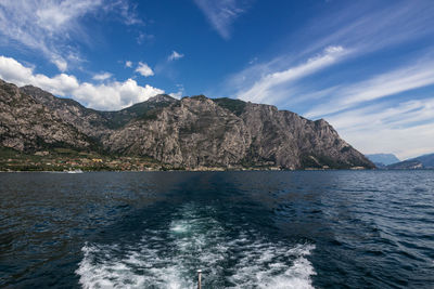 Scenic view of sea and mountains against sky