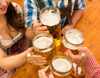 Friends toasting beer glasses at restaurant