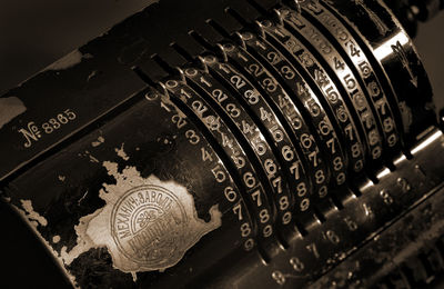 Close-up of numbers on antique cash register machine