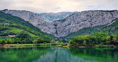 Scenic view of lake and mountains against sky