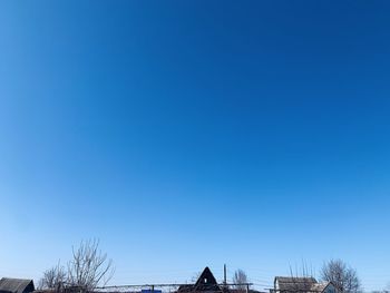 Low angle view of building against clear blue sky