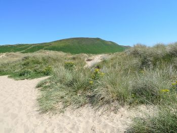 Scenic view of land against clear blue sky