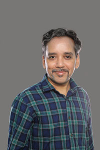 Portrait of a smiling man against black background