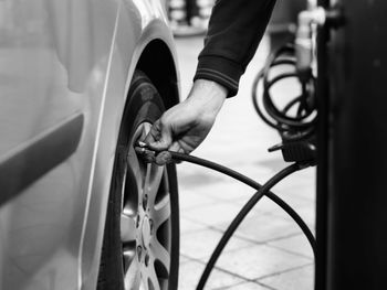 Low section of man repairing car