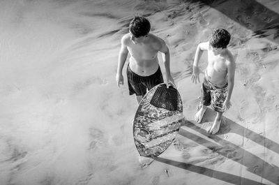 Rear view of couple standing at beach