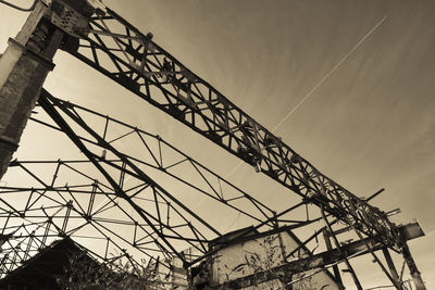 Low angle view of crane against sky