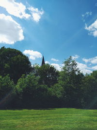 Scenic view of grassy field against cloudy sky