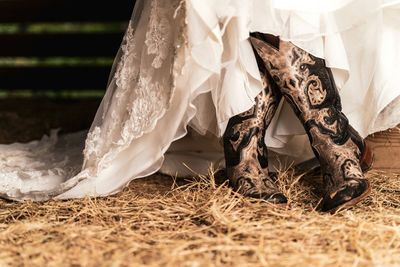 Low section of woman standing on field