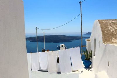 Fabrics on clothesline against sea