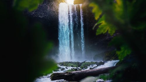 Low angle view of waterfall against sky