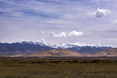 Scenic view of mountains against cloudy sky