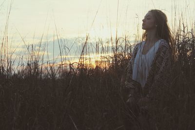 Young woman standing in grass